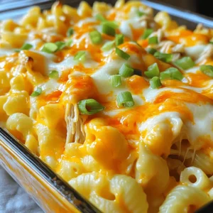 - 8 oz elbow macaroni - 2 cups cooked chicken, shredded - 1 cup buffalo sauce (adjust to taste) Buffalo Chicken Mac and Cheese starts with elbow macaroni. This pasta shape holds the sauce well. Next, use shredded chicken. You can roast or boil it for this dish. The star of this recipe is buffalo sauce. It adds heat and zest. Adjust the amount to fit your taste. - 2 cups sharp cheddar cheese, shredded - 1 cup mozzarella cheese, shredded - 2 tablespoons cream cheese For the creamy base, we need cheeses. Sharp cheddar cheese gives a strong flavor. Mozzarella cheese adds a nice stretch. Cream cheese makes the sauce rich and smooth. Together, these cheeses create a great blend. The creaminess balances the spicy buffalo sauce. - 1/2 teaspoon garlic powder - 1/2 teaspoon onion powder - Chopped green onions for garnish Seasonings boost the flavor. Garlic powder adds depth. Onion powder gives a sweet taste. You can sprinkle chopped green onions on top. They add a pop of color and a fresh bite. This dish is not just tasty; it looks great too! - Bring a large pot of salted water to a boil. - Add 8 oz of elbow macaroni to the pot. - Cook the macaroni until it is al dente, about 7-9 minutes. - Drain the pasta and set it aside in a bowl. - In a medium saucepan, melt 1 tablespoon of butter over medium heat. - Add 2 tablespoons of cream cheese and stir until it melts and blends. - Gradually whisk in 1/2 cup of milk until the mixture is smooth. - Stir in 2 cups of shredded sharp cheddar cheese and 1 cup of shredded mozzarella cheese. - Keep stirring until the cheese melts and the sauce thickens. - In a large mixing bowl, combine the cooked macaroni and 2 cups of shredded chicken. - Pour the cheese sauce over the pasta and chicken. - Mix well to ensure everything is evenly coated. - If you want a crispy topping, preheat your oven to 350°F (175°C). - Transfer the mac and cheese to a baking dish and top with extra cheese. - Bake for 15-20 minutes until the top is golden and bubbly. - Perfecting pasta al dente: Cook the elbow macaroni in salted boiling water. Check the package for timing. Aim for a firm bite, known as al dente. This keeps the pasta from getting mushy when mixed with the sauce. - How to prevent cheese from clumping: To keep cheese from clumping, shred it fresh. Pre-shredded cheese has additives that cause clumps. Add the cheese slowly to the warm sauce. Stir constantly for a smooth blend. - Adjusting buffalo sauce to taste: Start with the suggested amount of buffalo sauce. Taste as you mix. If you want more heat, add a bit at a time. You can always add more, but it’s hard to take out. - Adding extra spices for depth: Besides garlic and onion powder, consider adding smoked paprika or cayenne pepper. These spices can enhance the dish's flavor. Just a pinch can make a big difference. - Garnishing ideas: After serving, sprinkle chopped green onions on top. This adds color and a fresh taste. You might also use crumbled blue cheese for a classic touch. - Serving suggestions: Serve Buffalo Chicken Mac and Cheese in bowls for a cozy feel. Pair it with a simple side salad for balance. This makes your meal feel complete and satisfying. {{image_2}} You can make this dish lighter without losing flavor. Use whole wheat elbow macaroni for extra fiber. Swap out regular cheese for low-fat cheese options. You can also use plain Greek yogurt instead of cream cheese for a creamy texture with less fat. For the chicken, consider using grilled or baked chicken instead of fried for a healthier choice. Want to spice things up? Add diced jalapeños for heat. You can also mix in buffalo seasoning for extra flavor. If you’re not a fan of buffalo sauce, try ranch dressing or BBQ sauce. They add a different twist but keep the dish delicious. For those who need gluten-free meals, use gluten-free pasta. There are many good brands available that cook the same as regular pasta. If you want to make it vegetarian, replace the chicken with sautéed mushrooms or chickpeas. These options keep the dish hearty and satisfying without meat. To store leftovers, let the Buffalo Chicken Mac and Cheese cool first. Then, place it in an airtight container. Make sure to use a container that seals well to keep the dish fresh. I recommend glass or BPA-free plastic containers. They help prevent any strong smells from mixing with other foods in your fridge. You can freeze Buffalo Chicken Mac and Cheese for later. Just portion it into freezer-safe containers. Make sure to leave some space at the top for expansion. When you want to eat it, thaw it overnight in the fridge. To reheat, place it in the oven at 350°F (175°C) until hot. You can also use the microwave. Just heat in short bursts, stirring in between. In the fridge, this dish lasts about 3 to 4 days. Always check for signs of spoilage. If it smells off or has a strange texture, it's best to toss it. Keeping it covered well helps maintain its taste and quality. Can I use rotisserie chicken? Yes, you can use rotisserie chicken. It saves time and adds great flavor. Just shred the chicken and mix it in. How can I make it spicier? To make it spicier, add more buffalo sauce. You can also mix in some hot sauce for an extra kick. Can I make it ahead of time? You can prepare it ahead of time. Just cook the pasta and make the sauce. Combine them and store in the fridge. When ready, bake it for a nice finish. What can I serve with Buffalo Chicken Mac and Cheese? You can serve it with a simple salad. A side of veggies works well, too. Some crusty bread would be perfect for dipping. Can I use different types of cheese? Yes, you can use different cheeses. Try gouda or pepper jack for a twist. Just keep the total cheese amount the same. What’s a good substitute for buffalo sauce? A good substitute for buffalo sauce is ranch dressing or BBQ sauce. These will change the flavor but still taste great in the dish. Buffalo Chicken Mac and Cheese is a fun dish to make. We covered the main ingredients, from elbow macaroni to creamy cheese. I shared step-by-step instructions for cooking and mixing everything perfectly. Along with tips to enhance flavor and presentation, you learned about healthier and varied versions. Lastly, we discussed storage tips to keep leftovers fresh. Now you have a delicious recipe to try. Enjoy cooking and sharing this tasty meal!