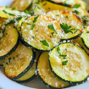 To make Garlic Parmesan Zucchini Chips, you need these key items: - 2 medium zucchinis, thinly sliced - 1 tablespoon olive oil - 2 cloves garlic, minced - 1/2 cup grated Parmesan cheese - 1 teaspoon dried oregano - 1 teaspoon paprika - Salt and pepper to taste You can add a little extra flair with these optional items: - Fresh parsley for garnish If you lack any key items, here are some good swaps: - Zucchini: Use yellow squash for a different taste. - Olive oil: Avocado oil works well too. - Parmesan cheese: Try nutritional yeast for a vegan option. - Dried oregano: Basil or Italian seasoning can be a nice change. - Paprika: Use cayenne for a spicy kick. These ingredients help create a tasty snack that is both crunchy and satisfying. When you mix them well, you get a flavor that everyone will love. Enjoy experimenting with your own twists! {{ingredient_image_1}} Start by preheating your oven to 225°F (110°C). I like to line a baking sheet with parchment paper. This helps with clean-up later. Next, grab two medium zucchinis. Slice them thinly, about 1/8 inch thick. Thin slices help create crunchy chips. In a large bowl, mix the sliced zucchini with one tablespoon of olive oil. Make sure each slice gets a light coat. Now, add two cloves of minced garlic to the bowl. Then, sprinkle in one teaspoon of dried oregano and one teaspoon of paprika. Add salt and pepper to taste. Toss everything well until the zucchinis are evenly coated with the seasonings. This step is key to ensuring every bite is flavorful. I recommend baking for a healthier option. Baking also gives the zucchini a nice crunch without the added oil from frying. Spread the seasoned zucchini slices in a single layer on the prepared baking sheet. Avoid overlapping them. This ensures they bake evenly and get crispy. Once arranged, generously sprinkle half a cup of grated Parmesan cheese over the top. Bake in your preheated oven for about two hours. Check them halfway through, and flip the slices for even cooking. Your goal is crispy, golden-brown chips. If you prefer frying, use hot oil in a pan. Fry until golden but watch carefully to avoid burning. To achieve even cooking, follow these steps. Always slice your zucchinis uniformly. Thin slices cook better and crisp up nicely. Make sure to space the slices apart on the baking sheet. Overcrowding leads to soggy chips. If you notice some chips are browning faster, you can rotate the baking sheet halfway through. This simple trick helps every chip get even heat and crispiness. For the best crunch, slice your zucchinis thinly. Aim for even slices about 1/8 inch thick. This helps them cook evenly. After slicing, soak them in salt for 10-15 minutes. This draws out moisture. Pat them dry with a clean towel before adding oil and seasonings. Bake them at a low temperature, around 225°F (110°C). This slow cooking allows for crispiness without burning. Flipping them halfway through helps, too. While garlic and Parmesan are key, feel free to get creative. Add herbs like thyme or basil for freshness. A sprinkle of chili flakes gives a nice kick. If you love a smoky taste, substitute paprika with smoked paprika. You can also try different cheeses. Grated cheddar or nutritional yeast can work well. Experiment with your favorite spices to find your perfect blend. One common mistake is overlapping zucchini slices. This traps moisture and makes them soggy. Always lay them out in a single layer. Another mistake is not drying the slices well after salting. Excess moisture leads to less crispiness. Lastly, resist the urge to add too much oil or cheese. A light coating is best for optimal crunch. Pro Tips Slice Evenly: Make sure to slice the zucchinis uniformly to ensure they bake evenly and reach the same level of crispiness. Use Fresh Garlic: Freshly minced garlic will provide a more robust flavor compared to pre-minced garlic, enhancing the overall taste of the chips. Check for Doneness: Keep an eye on the zucchini chips during the last few minutes of baking; they can go from perfectly crispy to burnt very quickly. Storage Tips: Store any leftover zucchini chips in an airtight container at room temperature to maintain their crunchiness for a couple of days. {{image_2}} You can use different cheeses to change the flavor. Try cheddar for a sharp taste. Feta adds a creamy, salty kick. If you love Italian flavors, use Pecorino Romano. Each cheese gives a unique twist to the chips. Mix and match to find your favorite! Experiment with seasonings for a new taste. Instead of oregano, try basil or thyme. If you want heat, add cayenne pepper or chili powder. For a zesty touch, use lemon zest or a dash of lemon juice. Each combination offers a fun, fresh bite. Add herbs and spices to make your chips special. Chopped fresh rosemary or thyme adds nice flavor. Garlic powder can boost the garlic taste. You can even sprinkle on nutritional yeast for a cheesy kick. These add-ins make your zucchini chips even better! Store your Garlic Parmesan Zucchini Chips in an airtight container. This keeps them fresh. Place a paper towel inside to absorb moisture. This simple step helps keep them crispy. Make sure to store them in a cool, dry place. Leftover chips can last up to three days this way. To get your chips crunchy again, preheat your oven to 350°F (175°C). Spread the chips on a baking sheet in a single layer. Heat them for about 5-10 minutes. You can also use an air fryer at 350°F for about 3-5 minutes. This method brings back their crispiness without making them soggy. Freezing zucchini chips is easy. First, let the chips cool completely. Then, place them in a single layer on a baking sheet and freeze for about an hour. Once frozen, transfer them to a freezer bag. Squeeze out excess air before sealing. They can stay fresh for up to three months. When you crave a snack, just reheat them right from the freezer! Yes, you can make Garlic Parmesan Zucchini Chips in an air fryer. Just slice the zucchinis thinly. Toss them with olive oil, garlic, and spices as in the oven method. Place the slices in a single layer in the air fryer basket. Cook at 350°F for about 10-15 minutes. Check them often to avoid burning. The air fryer gives a nice crunch, just like the oven. To keep the zucchini crispy, start by slicing it thinly. A thickness of about 1/4 inch works best. Before seasoning, sprinkle the slices with salt and let them sit for 10-15 minutes. This draws out excess moisture. After that, pat them dry with a paper towel. When you bake them, arrange the slices in a single layer and avoid overlapping. This helps them crisp up nicely. Garlic Parmesan Zucchini Chips pair well with many dips. Try serving them with marinara sauce, ranch dressing, or a creamy garlic dip. They also make a great side for sandwiches or burgers. For a fun twist, use them as a topping for salads, adding crunch and flavor. You can even serve them as a snack at parties! In this guide, we explored the ingredients needed for Garlic Parmesan Zucchini Chips. I shared useful cooking steps, great tips for crispiness, and fun variations. You now know how to store leftovers and reheat them perfectly. Remember to experiment with flavors and seasonings to find your favorite. Don't worry about mistakes; cooking is all about learning. Enjoy your tasty chips, and share them with friends or family for a delightful snack!