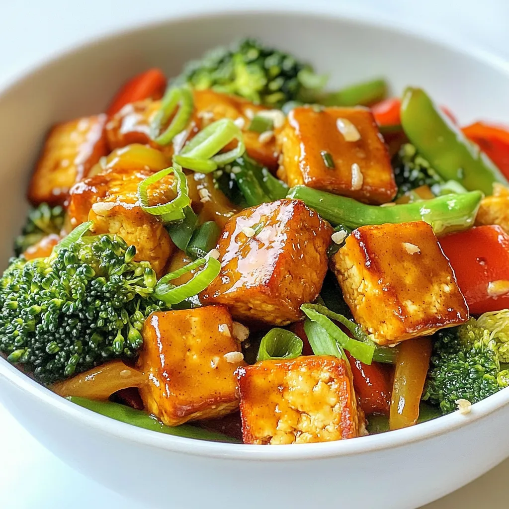 For a tasty tofu stir fry, you need: - 1 block extra-firm tofu, drained and pressed - 2 tablespoons cornstarch - 2 tablespoons vegetable oil - 1 bell pepper (red or yellow), sliced - 1 cup broccoli florets - 1 cup sugar snap peas - 2 cloves garlic, minced - 1 tablespoon fresh ginger, grated - 3 green onions, chopped - Salt and pepper to taste The extra-firm tofu gives your dish a great texture. Cornstarch helps make it crispy. Choose fresh vegetables for the best flavor. To make the peanut sauce, gather: - 1/3 cup natural peanut butter - 2 tablespoons soy sauce - 1 tablespoon maple syrup - 1 tablespoon lime juice - 1 teaspoon sesame oil - 1 tablespoon water (or more for desired consistency) This sauce adds a rich, nutty flavor. The lime juice brings a nice tang. Adjust the water to get your preferred sauce thickness. When choosing vegetables, look for these signs: - Bright colors show freshness. - Firmness means the veggies are crisp. - No brown spots or wilting. Fresh produce makes your stir fry taste better. Spend time picking the best veggies at the store. {{ingredient_image_1}} Start by cutting the pressed tofu into bite-sized cubes. Use a sharp knife for clean cuts. Pat the tofu dry with a paper towel to remove excess moisture. This step is key for a crispy texture. Next, toss the tofu cubes in cornstarch. Make sure each piece is evenly coated. This will help create a nice crispy crust when frying. Heat 1 tablespoon of vegetable oil in a large non-stick skillet or wok over medium-high heat. Add the tofu cubes in a single layer. Cook them until golden and crispy on all sides, about 8-10 minutes. Remove the crispy tofu and set it aside. In the same skillet, add the remaining tablespoon of oil. Toss in the sliced bell pepper, broccoli florets, and sugar snap peas. Stir-fry these veggies for about 3-4 minutes. You want them to be crisp-tender. In a small mixing bowl, combine all the peanut sauce ingredients. This includes the peanut butter, soy sauce, maple syrup, lime juice, sesame oil, and water. Whisk until the mixture is smooth. If you find the sauce too thick, add more water to reach your desired consistency. This sauce adds rich flavor to every bite. Return the crispy tofu to the skillet with the vegetables. Add the minced garlic and grated ginger, then stir-fry for another minute. Season with salt and pepper to taste. Pour the peanut sauce over the tofu and vegetables. Stir well to coat everything evenly. Cook for an additional 2 minutes to heat the sauce through. Finally, garnish with chopped green onions before serving. Enjoy your tasty tofu stir fry! To get crispy tofu, start with extra-firm tofu. Drain and press it well to remove moisture. Cut it into bite-sized cubes. Toss the cubes in cornstarch until they are fully coated. This step is key for that crunchy outside. Heat vegetable oil in your skillet over medium-high heat. Cook the tofu cubes in a single layer. Let them brown for about 8-10 minutes. Don’t overcrowd the pan. Flip them to cook all sides evenly. This method gives you that perfect crispy texture. To boost flavors, use fresh herbs and spices. Garlic and ginger add a bright kick to your stir fry. Mince the garlic finely and grate the ginger for best results. You can also add fresh herbs like cilantro or basil for a fragrant touch. Consider using red chili flakes if you want some heat. These simple additions will enhance your dish. They bring freshness and depth, making every bite exciting. For a smooth peanut sauce, mix the ingredients well. Start with natural peanut butter, soy sauce, maple syrup, lime juice, and sesame oil in a bowl. Add water to this mix until it reaches your desired thickness. If it feels too thick, stir in more water. A thinner sauce coats the tofu and veggies better. If you want a richer flavor, use less water. Finding that perfect balance makes your stir fry more enjoyable. Pro Tips Press Tofu Well: Ensure you press the tofu thoroughly to remove excess moisture. This helps achieve a crispy texture during frying. Use High Heat: Cooking the tofu and vegetables over medium-high heat will give you that delicious stir-fried flavor and a nice char. Customize Vegetables: Feel free to swap out or add any of your favorite vegetables, such as carrots or zucchini, to make the dish your own. Adjust Sauce Consistency: If the peanut sauce is too thick, gradually add more water until you reach your desired consistency for easy pouring. {{image_2}} You can swap tofu with different proteins. Tempeh is a great choice. It offers a nutty flavor and chewy texture. Chicken or shrimp works well, too. Just cook them until fully done before adding veggies. For a vegan option, use chickpeas. They add protein and fiber to your dish. Feel free to mix and match your veggies. In the spring, add asparagus or snap peas. In the fall, use butternut squash or Brussels sprouts. Seasonal veggies taste fresher and can change the dish's vibe. Just remember to cut them into similar sizes for even cooking. You can spice up the sauce in many ways. Add chili paste for heat or a splash of coconut milk for creaminess. Try a sesame or teriyaki sauce for a different taste. You can even use almond butter if you want a twist. Each variation will give you a unique flavor profile. To store your tofu stir fry, wait for it to cool. Place it in an airtight container. Make sure to separate the tofu and vegetables if you can. This helps keep the texture. Store it in the fridge for up to three days. If you want to keep it longer, consider freezing. When reheating, I suggest using a skillet. Heat it over medium heat and add a splash of water. This helps steam the dish. Stir often to prevent sticking. You want to keep that crispy tofu texture. Avoid using the microwave if you can; it can make everything soggy. To freeze your stir fry, pack it in a freezer-safe container. Leave some space for expansion. It will keep well for about a month. When ready to eat, thaw it overnight in the fridge. Reheat it on the stove to get it hot and crispy again. Enjoy your meal without the fuss of cooking! Yes, you can use different types of tofu. Soft or silken tofu works well in soups. However, for stir fry, extra-firm tofu is best. It holds its shape and gets crispy. If you prefer a softer texture, try firm tofu. Just know it may not crisp up as well. To make this dish gluten-free, swap soy sauce with tamari. Tamari is a gluten-free soy sauce. Also, ensure your peanut butter is pure and free from additives. Most cornstarches are gluten-free, but check the label. This way, you enjoy all the flavor without gluten. Serve tofu stir fry in a deep bowl. This allows for a nice presentation. Drizzle extra peanut sauce on top for added flavor. Sprinkle crushed peanuts and sesame seeds for crunch. You can also serve it with rice or noodles for a hearty meal. To make the peanut sauce spicy, add chili paste or sriracha. Start with a small amount and taste as you go. You can also add crushed red pepper flakes for heat. Adjust the spice level to your liking, and enjoy the extra kick! We’ve explored the essentials for a tasty tofu stir fry, from ingredients to cooking tips. You learned how to prepare tofu, cook veggies, and make a rich peanut sauce. Remember to choose fresh produce for the best flavor and texture. Try different proteins and sauces for unique twists. Store leftovers properly and reheat to enjoy them later. With these tips, you can create delicious meals that suit your taste and needs. Happy cooking!