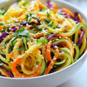 To make a Sesame Peanut Zoodle Salad, gather these fresh items: - 3 medium zucchinis, spiralized into noodles - 1 bell pepper (red or yellow), thinly sliced - 1 cup shredded carrots - 1 cup purple cabbage, thinly sliced - 1/2 cup cilantro, chopped - 1/4 cup green onions, chopped - 1/4 cup unsalted peanuts, roughly chopped - 1/4 cup soy sauce (or tamari for gluten-free) - 2 tablespoons creamy peanut butter - 2 tablespoons sesame oil - 1 tablespoon rice vinegar - 1 tablespoon honey or maple syrup (for a vegan option) - 1 teaspoon grated ginger - Sesame seeds for garnish Feel free to add or change ingredients to make this salad your own. Here are some ideas: - Cherry tomatoes for a sweet burst - Cucumber for extra crunch - Edamame for added protein - Avocado for creaminess - Sriracha for heat This salad is not just tasty; it packs a nutritional punch. Each serving is rich in vitamins and minerals. Here's a quick breakdown: - Calories: Approximately 200 - Protein: About 7 grams - Fat: Around 12 grams, mainly from healthy sources - Carbohydrates: Roughly 20 grams - Fiber: Approximately 4 grams This salad is light but filling. It's perfect for lunch or dinner. Enjoy the fresh flavors and vibrant colors! {{ingredient_image_1}} Start by spiralizing the zucchinis. Use a spiralizer to turn them into noodles. Place the zoodles in a large bowl. This base gives the salad a nice, crunchy texture. Slice the bell pepper thinly and add it to the bowl. Next, shred the carrots and toss them in. Then, slice the purple cabbage and add it as well. Chop the cilantro and green onions. Mix all the veggies gently to combine. Make sure everything is evenly distributed. This mix adds color and flavor to your salad. In a small bowl, whisk together the soy sauce or tamari. Add the creamy peanut butter and sesame oil. Then, pour in the rice vinegar and honey or maple syrup. Grate some ginger and add it to the mix. Whisk until smooth and well combined. This dressing ties the whole salad together for a rich taste. After making the dressing, pour it over the zoodle salad. Toss everything well to coat the zoodles and veggies. Let it sit for about 10 minutes. This helps the flavors blend and softens the zoodles a bit. To spiralize zucchini, choose firm, fresh zucchinis. Wash them well and cut off the ends. Use a spiralizer for even noodles. Turn the zucchini as you spiralize. This gives you long, uniform zoodles. If you find the zoodles too watery, pat them dry with a clean towel. This step helps keep the salad crisp. To make the salad shine, use fresh ingredients. Fresh cilantro and ginger add a punch. Toasting the peanuts brings out their rich flavor. You can also add a splash of lime juice for a zesty kick. If you want more heat, try adding a bit of chili paste or flakes. Experiment with the dressing too; swap honey for maple syrup for a vegan touch. This salad works great for meal prep. Spiralize the zucchini and store it in an airtight container. Keep the dressing separate until you are ready to eat. This keeps the zoodles crunchy. You can mix in other veggies too. Carrots and bell peppers are great choices. Prepare a large batch and enjoy it throughout the week! Pro Tips Use Fresh Ingredients: For the best flavor and texture, use fresh, organic vegetables whenever possible. Adjust the Sauce: Feel free to modify the dressing ingredients to suit your taste; add more peanut butter for creaminess or more vinegar for tang. Chill Before Serving: For a refreshing taste, let the salad chill in the fridge for about 30 minutes before serving. Experiment with Toppings: Try adding other toppings like avocado, sesame seeds, or even grilled chicken for extra protein. {{image_2}} Adding protein makes this salad even better. You can use cooked chicken or tofu for a tasty boost. For chicken, grill or bake it first. Then, slice it into strips and add it to the salad. If you prefer tofu, use firm or extra-firm tofu. Pan-fry or bake it until golden. Then, cube it and mix it in with the zoodles. Both options add flavor and make the dish more filling. If you want to change the flavor, try different dressings. You can swap the soy sauce for a spicy sauce for a kick. A sesame ginger dressing adds a fresh twist. For a creamy option, use tahini instead of peanut butter. You can also mix in lime juice for a zesty note. Feel free to experiment until you find your favorite dressing! Using seasonal vegetables can make this salad even more exciting. In summer, add fresh corn or cherry tomatoes. In fall, try roasted butternut squash or sweet potatoes. You can also use seasonal greens like spinach or arugula. Just remember to slice them thinly. Mixing in these veggies keeps the salad fresh and reflects what&rsquo;s in season. Enjoy the vibrant colors and flavors! To keep your zoodle salad fresh, store it in an airtight container. Make sure to remove excess air. You can place it in the fridge right after serving. When you store the salad this way, it stays crisp and tasty. The zoodle salad stays good for about three days in the fridge. After that, the veggies may lose their crunch. The dressing can last up to a week if stored separately. Always check for freshness before you eat. Reheating zoodles is easy. However, I recommend eating them cold for the best taste. If you prefer warm zoodles, heat them gently in a pan. Do this for just a minute or two to avoid mushiness. Enjoy your meal fresh and flavorful! Yes, you can make this salad ahead of time. Just prepare the zoodles and veggies. Store them in the fridge in an airtight container. Keep the dressing separate. This way, the salad stays fresh and crunchy. When you're ready to eat, mix in the dressing. Let it sit for a few minutes to soak in the flavor. To add some heat, try these options: - Add a pinch of red pepper flakes to the dressing. - Mix in sriracha or chili paste for a kick. - Use spicy peanuts instead of regular ones. These small changes can really spice things up without losing the salad's charm. If you want to swap peanuts, here are some great choices: - Almonds add nice crunch and flavor. - Cashews provide a creamy texture. - Sunflower seeds are a great nut-free option. These substitutes will keep your salad tasty and satisfying. This blog post covered how to make a fresh zoodle salad. We discussed key ingredients, step-by-step instructions, and helpful tips to enhance your dish. You learned about protein additions and seasonal swaps to keep your meals exciting. Proper storage and reheating techniques help you enjoy leftovers too. Overall, this zoodle salad is easy to customize, tasty, and healthy. It&rsquo;s a fun way to enjoy veggies and make meals more exciting. Give it a try and enjoy every bite!