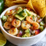 For the best ceviche, I use one pound of fresh shrimp. Make sure they are peeled and deveined. Fresh shrimp gives the dish a sweet and clean taste. Cut the shrimp into small, bite-sized pieces. This helps the shrimp absorb the lime juice well. Ceviche needs fresh veggies to balance the flavor. I add one cup of diced cucumber for crunch. Diced tomatoes add color and juiciness; one cup works well. Finely chop half a red onion to give it a sharp bite. I also use one minced jalapeño pepper, which adds a touch of heat. Remove the seeds if you want less spice. Finally, I include a quarter cup of fresh cilantro for a burst of herb flavor. To tie everything together, I season with salt to taste. The lime juice acts as the main seasoning, so adjust carefully. For serving, I garnish with extra cilantro and lime wedges. I love to serve the ceviche with crispy tortilla chips for a delightful crunch. The chips make every bite fun and enjoyable! {{ingredient_image_1}} Start with 1 pound of fresh shrimp. Peel and devein them. Cut the shrimp into small, bite-sized pieces. Place the shrimp in a non-reactive bowl. This helps keep the flavor bright and true. Now, pour in 1 cup of fresh lime juice. Make sure the shrimp are fully submerged. The lime juice will cook the shrimp. Cover the bowl with plastic wrap. Refrigerate for about 30 minutes. You will know it’s ready when the shrimp turn pink and opaque. While the shrimp marinates, prepare your veggies. In a large bowl, mix together 1 cup of diced cucumber, 1 cup of diced tomatoes, and 1/2 finely chopped red onion. Next, add 1 minced jalapeño pepper and 1/4 cup of chopped cilantro. This mix adds crunch and color. After 30 minutes, take the shrimp out. Drain any excess lime juice. Gently fold the shrimp into the vegetable mixture. Taste and add salt as needed. Finally, add 1 diced avocado. Mix gently to keep the avocado intact. Serve the ceviche chilled. You can scoop it into small bowls or halved avocado skins. This makes for a lovely presentation. Pair it with crispy tortilla chips for a fun crunch. Enjoy the bright flavors and fresh textures! When selecting shrimp, look for ones with a firm texture and a clean smell. Fresh shrimp should have a slight ocean scent, not a strong fishy odor. Always buy shrimp that is kept on ice. If possible, ask your fishmonger when the shrimp were caught for the best quality. For this recipe, use wild-caught shrimp if you can. They taste better and are often more sustainable than farmed shrimp. The lime juice is key to this ceviche. It not only adds flavor but also cooks the shrimp. Use fresh limes for the best taste. You'll need about eight limes to get one cup of juice. Pour the lime juice over the shrimp and ensure they are fully covered. This will help them turn pink and opaque. Let the shrimp marinate for about 30 minutes in the fridge. Keep an eye on the color change; this shows the shrimp are done. It's easy to overcook shrimp in the lime juice. To prevent this, stick to a 30-minute marinating time. After that, check the shrimp’s color. They should look pink and opaque but not rubbery. If you let them sit too long, they might become tough. If you prefer, you can cook the shrimp briefly before marinating. This gives you more control over the texture. Just remember, ceviche is all about that fresh, bright flavor. Pro Tips Freshness is Key: Always use the freshest shrimp available to ensure the best flavor and texture in your ceviche. Adjust the Heat: If you prefer a milder ceviche, always remove the seeds from the jalapeño. You can also substitute it with a milder pepper. Chill Before Serving: Let the ceviche sit in the refrigerator for an additional 10-15 minutes after mixing to enhance the flavors before serving. Serve with Style: For a beautiful presentation, serve ceviche in halved avocado skins or small glass cups to showcase the colorful ingredients. {{image_2}} You can switch shrimp for other seafood. Fish like tilapia or mahi-mahi work well. They taste great when marinated in lime juice. For a vegetarian option, use firm tofu. It absorbs flavors nicely and adds a unique twist. Experiment with bold flavors to change your ceviche. Add mango or pineapple for sweetness. This adds a tropical touch and brightens every bite. You can also mix in fresh herbs like basil or mint for a fresh taste. Try different peppers for heat. A serrano pepper gives a nice kick. Dietary needs can easily change this dish. For gluten-free options, skip tortilla chips and use veggie sticks. If you're avoiding onions, try using green onions instead. They add a mild flavor and crunch. For a low-carb meal, serve ceviche in lettuce wraps. This keeps it fresh and light. To store leftover ceviche, place it in a tight container. Make sure the lid seals well. This keeps air out and helps keep it fresh. Store the ceviche in the fridge. It is best eaten within one day for the best taste. To keep your ceviche fresh, avoid adding avocado until serving. This keeps the avocado from browning. You should also avoid mixing it with chips until you are ready to eat. If you follow these tips, your ceviche will stay tasty and vibrant. Freezing ceviche is not ideal. The shrimp and veggies may lose their crispness when thawed. If you must freeze it, store the shrimp and veggies separate from the lime juice. When ready to eat, thaw in the fridge overnight. Then mix everything together just before serving. Ceviche is a fresh seafood dish. It primarily features fish or shrimp. The seafood marinates in citrus juice, usually lime. This process "cooks" the seafood with acid. Ceviche often includes vegetables, like tomatoes and onions. It is a popular dish in many coastal regions. Each region has its unique twist on ceviche. Ceviche stays fresh in the fridge for up to two days. After that, it may lose flavor and texture. Always store it in an airtight container. Keep it cold to maintain its quality. The sooner you eat it, the better it tastes! Yes, you can use frozen shrimp. Just ensure you thaw them properly. Rinse them under cold water until they are fully thawed. After thawing, pat them dry with a paper towel. This helps keep the ceviche from becoming too watery. Ceviche is safe when prepared correctly. Ensure you use fresh shrimp and clean ingredients. The lime juice helps kill harmful bacteria. However, if you are pregnant or have a weakened immune system, consult your doctor first. Always prioritize food safety when enjoying this delicious dish! You learned how to make a delicious ceviche with fresh shrimp and tasty veggies. We covered marinating shrimp, serving ideas, and helpful tips. You now know how to choose the best ingredients and keep your ceviche fresh. Ceviche is fun to make and can fit many diets. Experiment with flavors and enjoy your fresh dish! Don’t hesitate to try it out and share it with friends!