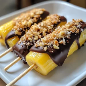 - Ripe bananas - Dark chocolate chips - Coconut oil - Crushed nuts (almonds, walnuts, or pistachios) - Shredded coconut - Popsicle sticks You need a few simple items to make chocolate covered banana pops. Start with ripe bananas. They should be soft but not brown. Next, gather dark chocolate chips. I love using dark chocolate for a rich taste. You also need coconut oil. It helps the chocolate melt smoothly. For a crunchy touch, pick some crushed nuts. You can use almonds, walnuts, or pistachios. I like a mix for variety. Shredded coconut adds a nice texture too. Choose unsweetened if you want a less sweet treat. Lastly, don’t forget popsicle sticks. They hold the banana pieces well. These ingredients make a fun and tasty treat! Each one adds to the flavor and texture. So, stock up on these items, and you're ready to create something delicious. {{ingredient_image_1}} To start, peel the ripe bananas. Next, cut each banana into three equal pieces. You want them to be about the same size for even pops. Insert a popsicle stick into each piece. Push it in gently, so the banana stays intact. Handle the bananas carefully. They can bruise easily, and you want them to look nice. For the chocolate, grab a microwave-safe bowl. Add the dark chocolate chips and coconut oil. This oil helps the chocolate melt smoothly. Microwave the bowl in 30-second intervals. Stir the chocolate in between to avoid burning. You want a shiny, smooth consistency. If it becomes too thick, add a tiny bit more coconut oil. Now it's time to coat the banana pops. Dip each banana into the melted chocolate. Make sure to cover it fully. Let any excess chocolate drip off. This step is important. Too much chocolate will make them messy. After that, roll the pops in crushed nuts or shredded coconut. This adds crunch and flavor. Place the coated pops on a baking sheet lined with parchment paper. Once done, freeze them for at least one hour. Enjoy your tasty treat! For the best flavor, I suggest using dark chocolate chips. They add a rich taste that pairs well with bananas. If you prefer a sweeter option, you can use milk chocolate chips. Just remember, the darker the chocolate, the less sweet it will be. To avoid clumps of chocolate, mix in a bit of coconut oil. This helps the chocolate melt smoothly. Make sure to microwave the chocolate in small bursts. Stir well in between to keep it even and creamy. You can get creative with toppings! Try crushed nuts like almonds, walnuts, or pistachios. They add a nice crunch. Shredded coconut gives a tropical twist. You can also mix and match these toppings for extra fun. For flavor variations, consider adding spices. A sprinkle of cinnamon can enhance the taste. You could also try different flavored chocolates, like mint or orange, for a unique twist. To present your banana pops nicely, place them on a colorful plate. You can even stand them in a glass for a fun display. This makes them look festive and inviting. Pair your banana pops with a side of yogurt or a scoop of vanilla ice cream. This combination makes for a delightful snack! Enjoy your creations with friends or family for a perfect treat time. Pro Tips Choose Ripe Bananas: Make sure your bananas are ripe but not overripe for the best flavor and texture. Use Quality Chocolate: Opt for high-quality dark chocolate for a richer taste that complements the bananas perfectly. Experiment with Toppings: Don't hesitate to try different toppings like sprinkles or sea salt for a unique twist on flavor. Store Properly: Store any leftover pops in an airtight container in the freezer to keep them fresh. {{image_2}} You can make chocolate-covered banana pops even healthier. Start with dark chocolate instead of milk chocolate. Dark chocolate has less sugar and more antioxidants. It adds a rich flavor that pairs well with bananas. For toppings, try using healthy options. Instead of crushed nuts, sprinkle chia seeds or hemp hearts. These add crunch and extra nutrients. You can also use unsweetened coconut. It keeps the flavor but cuts down on sugar. Want to spice things up? Add cinnamon or a pinch of chili powder to the chocolate. It gives your pops a warm kick. Just mix it in while melting the chocolate. You could also try flavored chocolate. Look for options like orange or mint. These flavors can change the whole taste of your banana pops. Make your banana pops fit the season! For holidays, use festive toppings. Try crushed candy canes for winter or colorful sprinkles for birthdays. You can also mix in other fruits. Strawberries or raspberries can add a burst of flavor. Pair them with bananas for a fun twist. Get creative with the seasons! To store banana pops for best freshness, place them in a single layer on a baking sheet. Cover them with plastic wrap or use a freezer bag. This helps keep them safe from air. For extra protection, wrap each pop in foil. This prevents freezer burn. To prevent freezer burn, make sure the pops are tightly sealed. Air makes the chocolate lose its flavor and texture. Also, try to keep the pops away from strong-smelling foods in the freezer. Banana pops can last in the freezer for about three months. After that, they may lose flavor and texture. Always check for signs of spoilage. If the chocolate looks dull or if there are ice crystals, it’s time to toss them. Watch for any strange smells or off flavors. If you notice these signs, it's best to discard the pops. Keeping them well-wrapped helps maintain their quality. To enjoy banana pops after freezing, let them sit at room temperature for a few minutes. This helps them soften slightly. You can also microwave them for about 10-15 seconds. Be careful not to overheat them, as this may cause the chocolate to melt too much. Avoid melting during reheating by using low power settings on your microwave. If you prefer, you can enjoy them straight from the freezer. They make a perfect cool treat on a hot day! Yes, you can use other fruits! Some great options are strawberries, apples, or peaches. These fruits will also taste great when coated in chocolate. Just cut them into bite-sized pieces and insert a popsicle stick. You can enjoy the same fun and flavor with different fruits. Feel free to experiment with what you have on hand. You can tell the banana pops are ready when they feel firm to the touch. After freezing for at least one hour, check them by gently pressing the side. If they hold their shape, they are set. If they feel soft, give them more time in the freezer. Properly frozen pops will be nice and cold. If your chocolate seizes, don't worry! This happens when it gets too hot or has moisture. To fix it, add a small amount of coconut oil or vegetable oil and stir well. Heat it gently in the microwave for a few seconds if needed. This can help bring the chocolate back to a smooth texture. Always melt chocolate slowly to avoid this issue. You now know how to make tasty banana pops. We covered the ingredients, steps to prepare, and tips for perfecting your treat. You can customize flavors, explore healthy options, and create fun seasonal themes. Remember to store them well for freshness. Enjoy experimenting with your favorite toppings and flavors. With practice, you’ll master these delicious snacks. Happy popping!