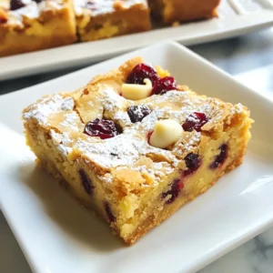 Here&rsquo;s what you need to make your cranberry white chocolate blondies: - 1 cup unsalted butter, melted - 1 cup brown sugar, packed - 1/2 cup granulated sugar - 2 large eggs - 2 teaspoons vanilla extract - 2 cups all-purpose flour - 1 teaspoon baking powder - 1/2 teaspoon baking soda - 1/4 teaspoon salt - 1 cup white chocolate chips - 1 cup dried cranberries These ingredients come together to create a sweet treat. The melted butter adds richness. Brown sugar gives a nice caramel flavor. The eggs provide moisture and help bind the mix. Using all-purpose flour helps achieve a soft texture. Baking powder and baking soda work together to make the blondies rise. The salt balances the sweetness. White chocolate chips bring creamy flavor. Dried cranberries add a tart kick that pairs well with the other ingredients. When you gather these ingredients, make sure they're fresh. This will ensure your blondies taste their best. Enjoy the process of mixing and baking! {{ingredient_image_1}} 1. Prepping the baking pan and preheating the oven: First, preheat your oven to 350&deg;F (175&deg;C). Line a 9x13 inch baking pan with parchment paper. Leave some paper hanging over the sides. This helps with easy removal later. 2. Mixing wet ingredients together: In a mixing bowl, combine 1 cup of melted unsalted butter with 1 cup of packed brown sugar and 1/2 cup of granulated sugar. Whisk this mixture until it is smooth and well combined. 3. Combining dry ingredients with the wet mixture: In a separate bowl, whisk together 2 cups of all-purpose flour, 1 teaspoon of baking powder, 1/2 teaspoon of baking soda, and 1/4 teaspoon of salt. Gradually add the dry mix to the wet mixture. Stir gently until just combined. 4. Folding in chocolate chips and cranberries: Now, fold in 1 cup of white chocolate chips and 1 cup of dried cranberries. Make sure they are evenly mixed throughout the batter. 5. Pouring batter into the pan and baking process: Pour the batter into your prepared baking pan. Use a spatula to spread it evenly. - Recommended baking temperature: Set your oven to 350&deg;F (175&deg;C) for baking. - Ideal baking duration: Bake the blondies for 25 to 30 minutes. You&rsquo;ll know they are done when the edges are golden brown. A toothpick inserted in the center should come out clean. - Cooling tips for best texture: Let the blondies cool in the pan for about 15 minutes. Then, lift them out using the parchment paper edges. Place them on a wire rack to cool completely. - Cutting and serving suggestions: Once cooled, slice the blondies into squares. For an elegant touch, dust with powdered sugar. Serve with a scoop of vanilla ice cream for a delightful treat. To bake the best cranberry white chocolate blondies, you need to avoid common mistakes. Here are some tips: - Measure accurately: Use a kitchen scale or measuring cups. Too much flour can make them dry. - Don&rsquo;t overmix: Mix until just combined. Overmixing can make your blondies tough. - Check the oven temperature: An oven thermometer helps ensure your oven bakes at the right heat. For the right texture, follow these steps: - Use room temperature eggs: They blend better with the batter. This gives your blondies a smooth texture. - Cool properly: Let them cool in the pan for 15 minutes before moving them. This helps them set well and stay soft. Making your blondies look great is easy. Here are some ideas: - Dust with powdered sugar: This adds a lovely finish. Just sprinkle it on top before serving. - Serve with ice cream: A scoop of vanilla ice cream pairs beautifully with the warm blondies. It adds creaminess and contrast. For special occasions, consider cutting them into fun shapes or adding festive decorations. This makes them stand out on any dessert table! Pro Tips Use Room Temperature Ingredients: Ensure that your eggs and butter are at room temperature for a smoother batter and better incorporation. Don&rsquo;t Overmix: Stir the dry ingredients into the wet mixture until just combined to avoid tough blondies. Check for Doneness: Since ovens vary, start checking your blondies a few minutes before the suggested baking time to prevent overbaking. Storage Tips: Store blondies in an airtight container at room temperature for up to a week, or freeze them for longer storage. {{image_2}} You can change things up in your cranberry white chocolate blondies for fun. Here are some options: - Different Types of Chocolate: Instead of white chocolate, try dark or milk chocolate. Each type brings a new flavor. You can even mix them for a twist! - Alternative Mix-ins: Add nuts like walnuts or pecans for crunch. If you love coconut, shredded coconut works great too. These swaps can change the texture and taste. If you have dietary needs, you can still enjoy these blondies. - Gluten-free Adaptations: Use gluten-free flour instead of all-purpose flour. Make sure it has a good blend for baking. This way, everyone can enjoy your blondies. - Vegan Version Suggestions: To make these blondies vegan, swap eggs with flax eggs or applesauce. Use dairy-free chocolate chips to keep it plant-based. These changes keep the taste delicious! To keep your cranberry white chocolate blondies fresh, follow these tips: - Cool Completely: Let the blondies cool fully on a wire rack before storing. - Use Airtight Containers: Place them in an airtight container. This keeps them moist and soft. - Layering: If you stack the blondies, place parchment paper between layers. This prevents sticking. You can store them at room temperature for up to five days. If you want them to last longer, consider freezing them. Freezing blondies is easy. Here&rsquo;s how to do it right: - Wrap Well: Cut the blondies into squares. Wrap each piece in plastic wrap. Then, place them in a freezer-safe bag or container. - Label and Date: Write the date on the bag. This helps you remember when you froze them. To thaw frozen blondies, take them out of the freezer. Leave them in the fridge overnight or let them sit at room temperature for a few hours. Enjoy them warm or at room temperature for the best taste. Can I use fresh cranberries instead of dried? Yes, you can use fresh cranberries. Fresh cranberries add a tart flavor. They may make the blondies a bit more moist. If you choose fresh, chop them into smaller pieces. This helps them mix well in the batter. What can I substitute for eggs in this recipe? You can use mashed banana or applesauce as egg substitutes. Use 1/4 cup of either for each egg. This keeps the blondies moist and helps them rise. You may notice a slight fruit flavor but it can be pleasant. How can I make these blondies chewier? To make your blondies chewier, try adding more brown sugar. Brown sugar has more moisture than white sugar. You can also bake them for a shorter time. Keep an eye on them toward the end of baking. Can I make the batter ahead of time? Yes, you can make the batter ahead of time. Store it in the fridge for up to 24 hours. Just be sure to bring it back to room temperature before baking. This helps the blondies bake evenly. In this blog post, we covered how to make delicious cranberry white chocolate blondies. We listed all the key ingredients and provided step-by-step instructions for baking. We also shared helpful tips to perfect your blondies and suggested fun variations. Freshness and storage options were included to keep your treats tasty. Baking is fun and rewarding. Enjoy making these delicious blondies, and don't be afraid to experiment!