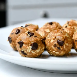 To make these tasty peanut butter oatmeal energy bites, gather these key ingredients: - 1 cup old-fashioned rolled oats - 1/2 cup creamy peanut butter - 1/3 cup honey or maple syrup - 1/4 cup ground flaxseed - 1/2 cup dark chocolate chips (or mini chocolate chips) - 1/2 teaspoon vanilla extract - A pinch of salt You can add some fun texture with these optional ingredients: - 1/4 cup shredded coconut - 1/4 cup chopped nuts These extras can give your bites a nice crunch and extra flavor. Need to make changes? Here are some smart substitutions: - Use almond butter or sunflower seed butter instead of peanut butter. - Swap honey with agave syrup for a vegan option. - Choose gluten-free oats if you need a gluten-free snack. These simple swaps can make the recipe work for many dietary needs. {{ingredient_image_1}} To start, gather your ingredients. You will need rolled oats, peanut butter, honey or maple syrup, ground flaxseed, dark chocolate chips, vanilla extract, and a pinch of salt. If you want extra texture, you can add shredded coconut or chopped nuts. 1. In a medium bowl, mix the rolled oats, ground flaxseed, and a pinch of salt. Stir well to combine. 2. In a second bowl, whisk the creamy peanut butter, honey or maple syrup, and vanilla extract until smooth. 3. Slowly pour the peanut butter mixture into the oat mixture. Stir continuously until everything is well mixed. 4. Now, fold in the dark chocolate chips and any optional ingredients. Make sure they are evenly spread throughout the mixture. When mixing, use a sturdy spoon to combine the ingredients. This helps ensure all the oats and peanut butter blend well. As you fold in the chocolate chips, be gentle to avoid breaking them. To roll the mixture into bites, use your hands. Take a small amount and shape it into a ball about one inch wide. This size is perfect for snacking. If you want, you can roll the bites in shredded coconut or chopped nuts to add a fun crunch. Chilling the mixture is key. It helps the bites hold their shape when you roll them. After mixing, place the bowl in the fridge for about 30 minutes. This makes it much easier to form the bites. Once chilled, take the mixture out and start rolling. Enjoy your energy bites right away or store them for later! Store your peanut butter oatmeal energy bites in an airtight container. This keeps them fresh. You can refrigerate them for up to a week. If you want to keep them longer, freeze them. Just place them in a freezer bag or container. When you're ready to eat, let them thaw in the fridge or at room temperature. You can mix up the flavors in many ways. Try adding spices like cinnamon or nutmeg for warmth. You can also switch the chocolate chips for dried fruit, like cranberries or raisins. Want more crunch? Add chopped nuts or seeds. For a tropical twist, throw in some shredded coconut. The choices are endless, so feel free to experiment! One common mistake is not chilling the mixture long enough. Chilling helps it firm up. This makes rolling easier. Another mistake is adding too many wet ingredients. This can make the bites too sticky. Stick to the recipe's balance for best results. Finally, don&rsquo;t skip the salt. A pinch of salt enhances all the flavors! Pro Tips Use Natural Nut Butters: Opt for natural peanut butter with no added sugars or hydrogenated oils for a healthier option and improved flavor. Chill for Easier Rolling: Chilling the mixture before rolling helps it firm up, making it easier to shape into uniform bites. Experiment with Add-ins: Feel free to customize your energy bites by adding different mix-ins like dried fruits, seeds, or spices for variety. Storage Tips: Store the energy bites in an airtight container to maintain freshness, and consider freezing them for longer storage. {{image_2}} You can easily switch up the flavors of your peanut butter oatmeal energy bites. If you love chocolate, add more dark chocolate chips or even cocoa powder. For a nutty taste, use almond butter instead of peanut butter. You can also toss in dried fruits like cranberries or raisins for a sweet twist. Each variation brings a new taste adventure! Making these bites fit your diet is simple. To make them vegan, use maple syrup instead of honey and choose a plant-based nut butter. For gluten-free bites, ensure your oats are specifically labeled gluten-free. You can still enjoy a tasty treat while sticking to your dietary needs! Want a different texture in your bites? You can swap in different ingredients. Try using chia seeds instead of ground flaxseed for a crunchier bite. If you like a chewier texture, add shredded coconut or chopped nuts. These swaps keep the recipe fresh and exciting! Store your Peanut Butter Oatmeal Energy Bites in an airtight container. This keeps them fresh. Place them in the fridge right after you make them. They stay good for about one week. If you see any moisture inside the container, it's best to toss them out. For longer storage, freeze the energy bites. First, roll them into balls as usual. Then, place the bites on a baking sheet. Freeze for about one hour until firm. After that, transfer them to a freezer-safe bag. Label the bag with the date. They will last up to three months in the freezer. To enjoy, just take a few out and let them thaw in the fridge. The energy bites have a shelf life of about one week in the fridge. Look for signs of spoilage before eating. If they smell off or have mold, it&rsquo;s time to throw them away. Always trust your senses! To make peanut butter oatmeal energy bites vegan, replace honey with maple syrup. This swap keeps the sweetness while ensuring it&rsquo;s plant-based. Be sure to use a vegan chocolate chip brand if you want chocolate in your bites. Most dark chocolate chips are already vegan, but check the label to be sure. Yes, you can use other nut butters! Almond butter, cashew butter, or sunflower seed butter all work well. Each option brings a unique flavor to the bites. Just keep the same amount as called for in the recipe. You might want to adjust sweeteners if the nut butter is sweeter or saltier. You can serve these energy bites as a quick snack or a healthy treat. They are great on their own. You can also pair them with fruit or yogurt. For a fun twist, roll them in shredded coconut or nuts before serving. These bites make perfect snacks for kids and adults alike! In this post, we covered the key steps to make energy bites, from ingredients to storage. You learned about optional items for texture and how to modify recipes for dietary needs. We also discussed mixing techniques, the chilling stage, and creative flavor ideas. Remember, mistakes happen, so try not to stress. With this guide, you can enjoy tasty, healthy snacks anytime. Keep exploring new flavors and have fun with your energy bites. You are now ready to make great snacks!